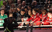 Liverpool manager Juergen Klopp and captain Virgil van Dijk prepare to lift the League Cup trophy after their victory in the final against Chelsea at Wembley Stadium in London on Sunday. 