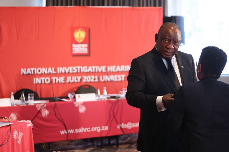 President Cyril Ramaphosa talks to members of his legal team after giving testimony at the SAHRC hearing on the July 2021 unrest. He said SA needed to go through a healing process after the deadly unrest that rocked the nation.