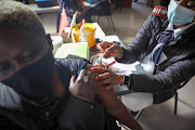 A nurse vaccinates a teacher at the Rabasotho Community Centre in Tembisa, Johannesburg. The Gauteng government said on Sunday a Covid-19 mobile vaccine drive will be launched this week.