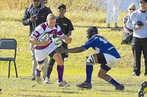 COMING THROUGH: Keagan Deonselle of Rhodes University runs with the ball while Tisetso Ramasenya of Limpopo attempts to defend during their match at the USSA Rugby Week in East London Picture: STEPHANIE LLOYD