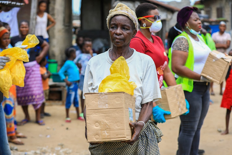 An elderly woman is seen with a food parcel she received from volunteers at a relief distribution, during a lockdown by the authories in efforts to limit the spread of the coronavirus disease (COVID-19), in Lagos, Nigeria. File photo