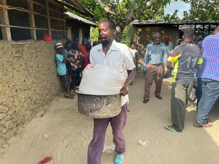 A man with his portion of relief food at Kibaoni camp in Lamu West.