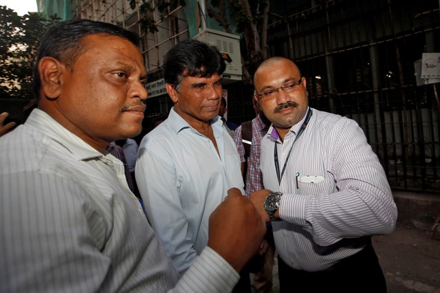 India's Central Bureau of Investigation (CBI) officials escort Gokulnath Shetty, one of the Punjab National Bank employees accused of steering fraudulent loans to companies linked to billionaire jeweller Nirav Modi, outside a court in Mumbai, India. File photo