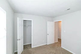 Bedroom looking towards closet and main entry door