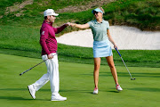 Branden Grace and Caroline Martens in action during the Berenberg Gary Player Invitational at GlenArbor Golf Club on October 01, 2018 in New York, United States of America.