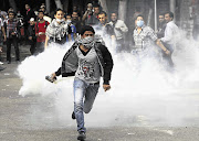 An anti-Morsi protester fights back during clashes with riot police at Tahrir Square in Cairo yesterday. Opponents of President Mohamed Morsi rallied a fifth day yesterday, stepping up calls to scrap a decree they say threatens Egypt with a new era of autocracy Picture: MOHAMED ABD EL GHANY/GALLO IMAGES