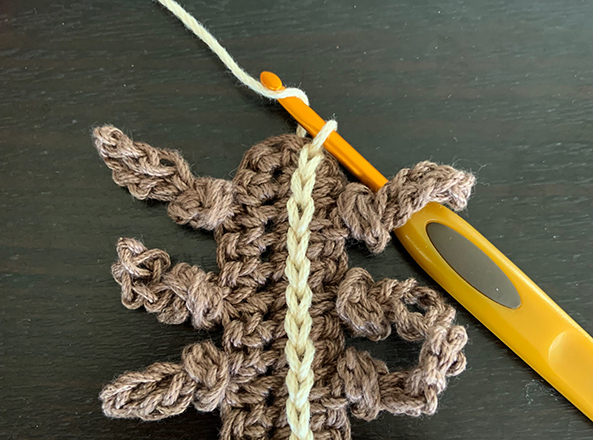 demonstrating how slip stitch crochet is worked over the end of single crochet.