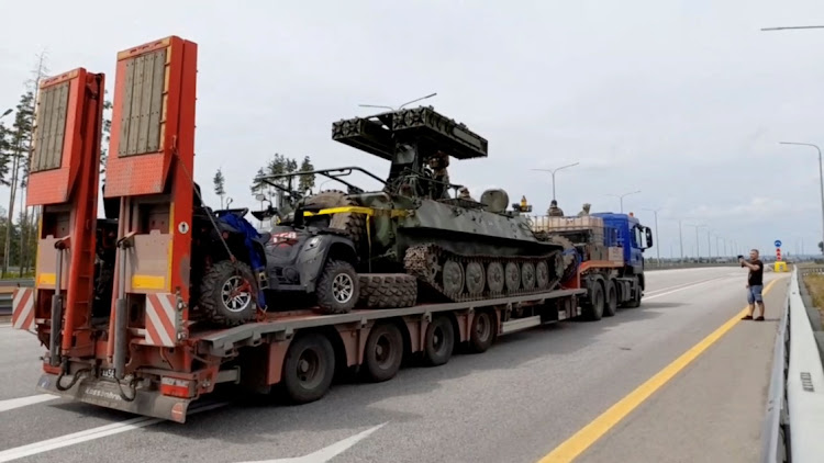 A truck transporting a military vehicle of Wagner private mercenary group drives along M-4 highway, which links the capital Moscow with Russia's southern cities, near Voronezh, Russia, on June 24 2023.