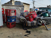 Sibusiso Vumase’s belongings lie strewn across his neighbour’s yard. 