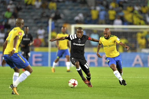 ON THE RUN: Thabiso Kutumela of Orlando Pirates and Oupa Manyisa of Mamelodi Sundowns scramble for possession during the Absa Premiership match between the two teams at Orlando Stadium on Wednesday night. Sundowns won 3-1.