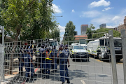 The two groups have been separated by a fence metres away from Luthuli House in Johannesburg.