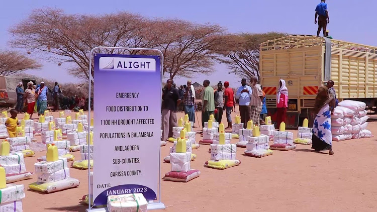 Residents of Banane, Garissa line up to receive food distribution from Alight-an NGO on Monday.