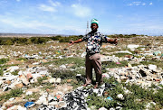 Ikhankatha (traditional nurse) Nyameko Jacobs shows the extent of illegal dumping at Zinyoka initiation school. 