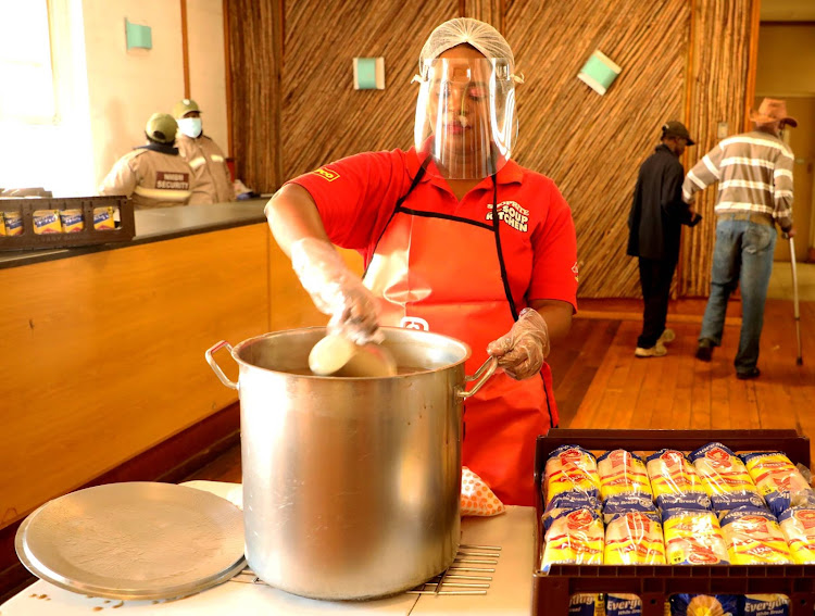 Nosipho Wonte, from the Red Cross Shoprite Mobile Soup Kitchen, gets ready to serve soup to homeless people housed at the Walmer Town Hall