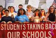 High school students observe a moment of silence in memory of the victims of the shooting at Marjory Stoneman Douglas High School, during a demonstration calling for safer gun laws outside the North Carolina State Capitol building in Raleigh, North Carolina, US. 