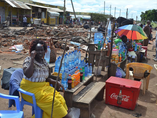 A trader operates in the open air following demolition of stalls at Kanyonyoo on April 28. /MUSEMBI NZENGU