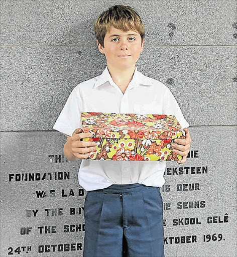 BOX OF FESTIVE CHEER: Grade 4 Selborne Primary School pupil Jason Tyler initiated the Santa Shoebox Project at his school to help disadvantaged pupils Picture: QAQAMBA MAGADLA