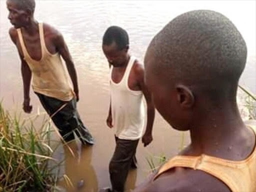 Rescuers at the scene where a 10-year-old boy drowned at a Dam in Musikoma ward, Bungoma County. /CLAUSE MASIKA