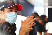 Sergio Perez of Mexico and Red Bull Racing looks on from the pitwall during Day One of F1 Testing at Bahrain International Circuit on March 12, 2021 in Bahrain, Bahrain.