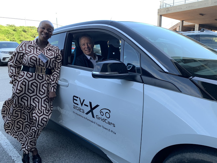 Eastern Cape department of economic development, environmental affairs and tourism head Mickey Mama and electric vehicles advisor Carel Snyman and his BMW i3 outside the conference at the Nelson Mandela Bay Stadium on Tuesday