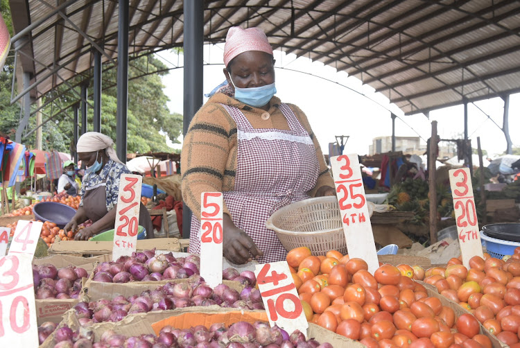 Trader Mary Wambui at Ruiru open-air market on Tuesday.