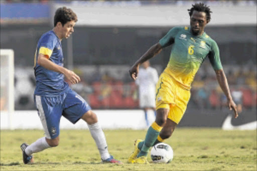 BACK FROM EXILE: Bafana Bafana striker Lerato Chabangu, right, fights for the ball with Brazil's Oscar during their international friendly match in Sao Paulo, Brazil, on Friday. Photo: Getty Images