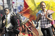 George Osumba, 12, from the DRC, and Trish Sibanda, 11 from Yeoville, lead an African Day Celebration parade in Johannesburg last month. Roughly 52% of Yeoville residents are from other African countries