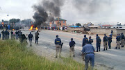 Police try to diffuse a total shutdown protest in Alexandra, in one of many similar protests to have hit South Africa this year.