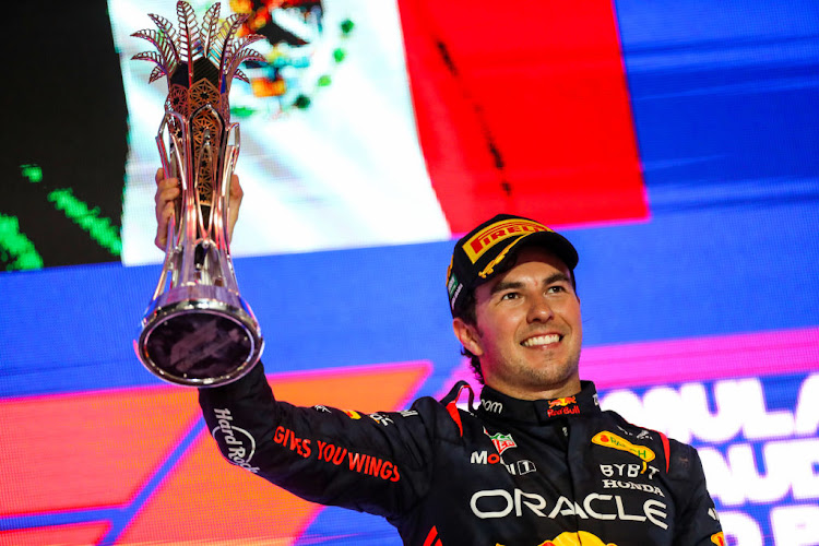 Sergio Perez celebrates on the podium after winning the F1 Grand Prix of Saudi Arabia at Jeddah Corniche Circuit on March 19, 2023 in Jeddah, Saudi Arabia.