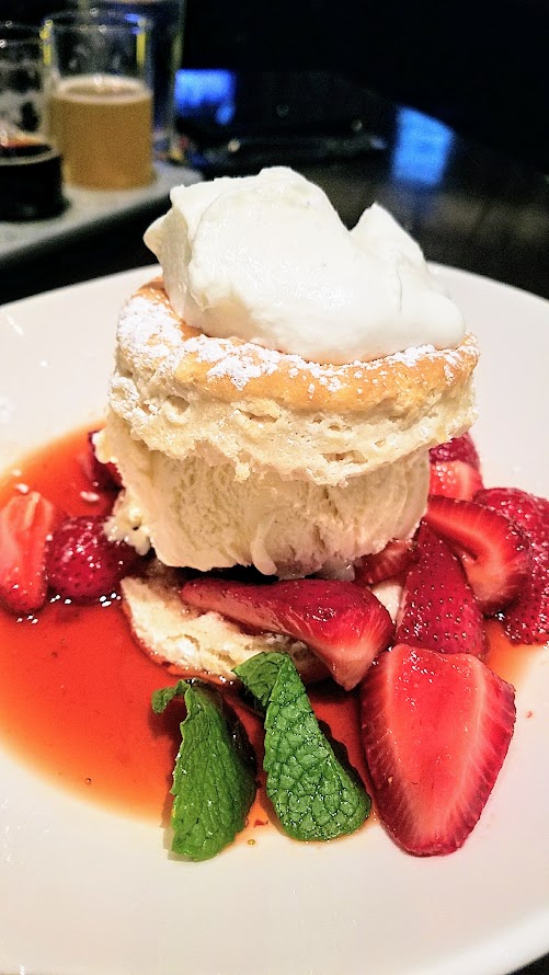 Yard House Strawberry Shortcake dessert with buttermilk biscuit, fresh strawberries, vanilla ice cream, whipped cream.