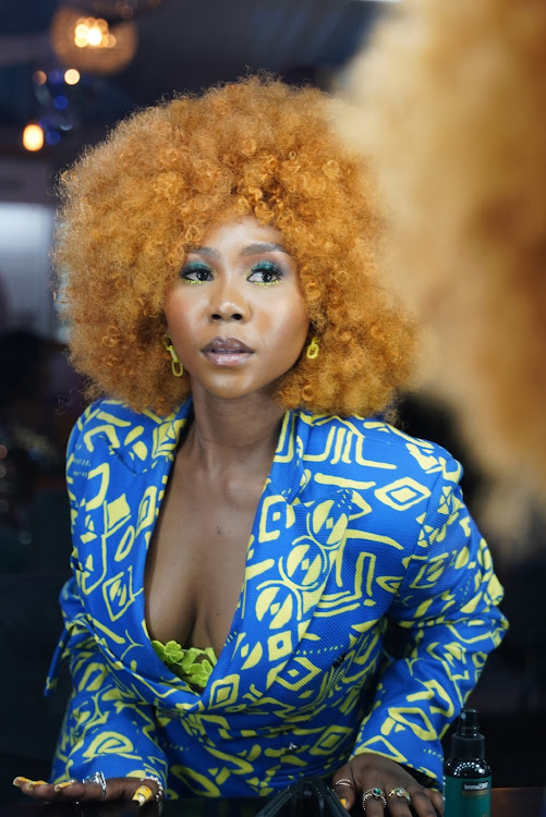 Artist Mel Madida in vibrant afro hairdo at the Durban July in Durban.