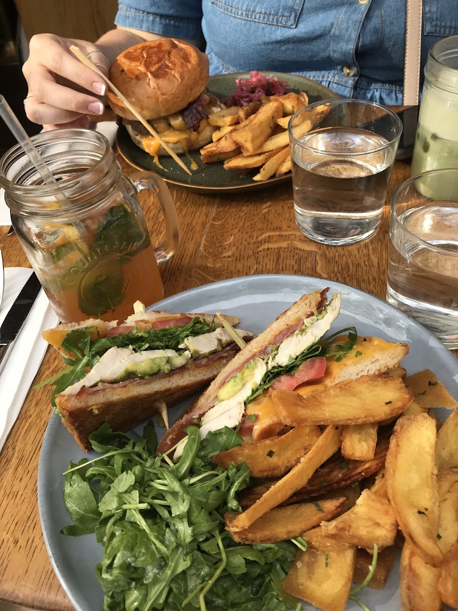 Gluten free chicken avocado club sandwich with GF fries. The burger pictured is on their non-GF bun but they can do it GF too!