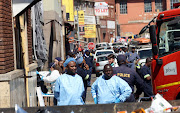 The forensic team outside the Marshalltown building which caught fire, killing 73 people  during the early hours of Thursday morning.