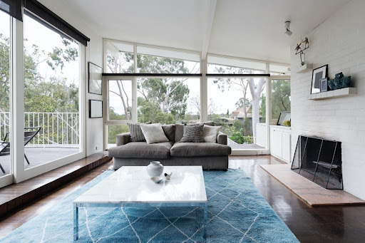 Living room with sofa and fireplace in this luxury property for sale in Chatou ($1,045,701 - 113 m²)