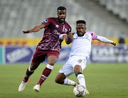 Mduduzi Mdantsane of Cape Town City is challenged by Wandisile Letlabika of Swallows FC during the league match between the two sides at Cape Town Stadium on December 18, 2021