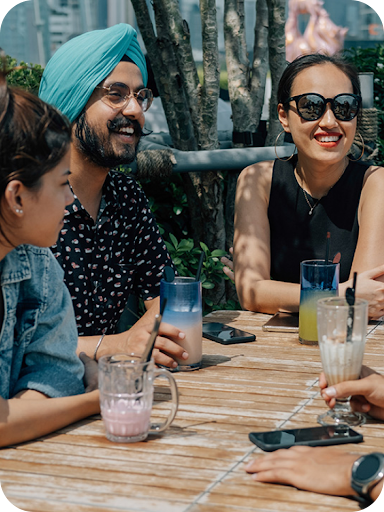 Four customers enjoy the drinks that they purchased using Tap and Pay on their smartphones.