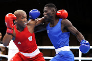 Simnikiwe Bongco (red) in action in his tournament opener against Foday Badjie of The Gambia. 