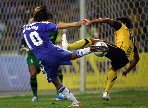 Yossi Benayoun of Chelsea (L) and Mohd Fandi of Malaysia compete for the ball during the pre-season friendly match between Malaysia and Chelsea at Bukit Jalil National Stadium on July 21, 2011 in Kuala Lumpur, Malaysia