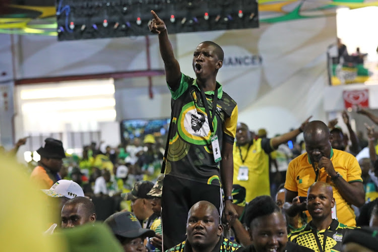 A delegate points at the podium as the results are announced.