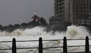 Huge waves caused by a massive storm that hit parts of the Western Cape crash against an embankment at Mouille Point in Cape Town on Thurday.