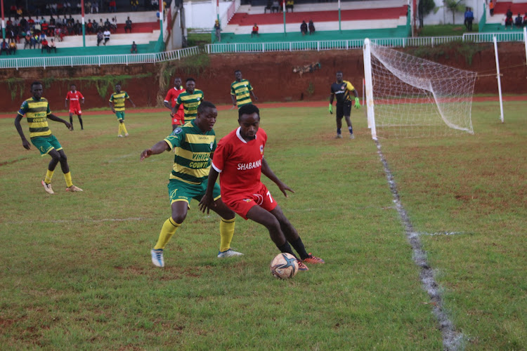 Isaac Otieno of Shabana shields the ball from a Vihiga United defender during an NSL game at Gusii Stadium