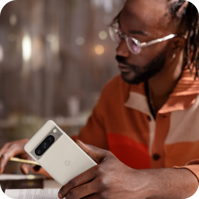 A man using a Google Pixel 8 phone to work.