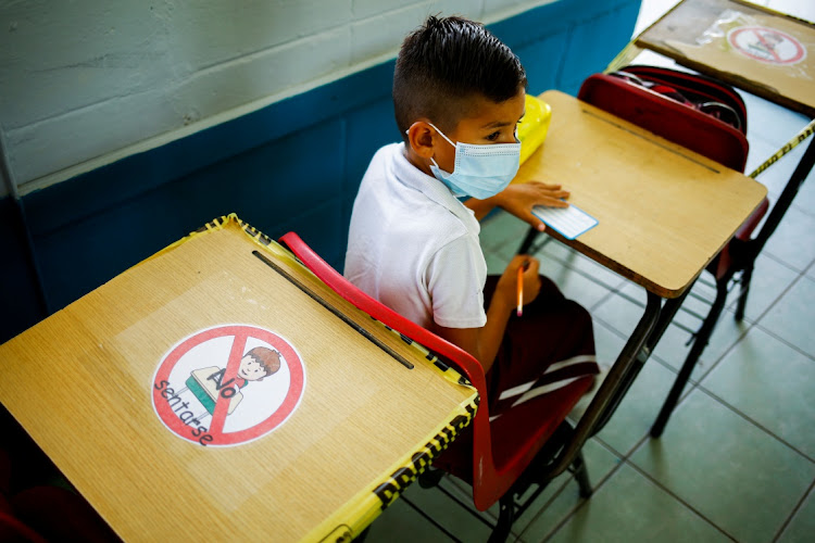 A student wearing a protective mask attends a class in person after more than a year of online lessons as the coronavirus disease (Covid-19) outbreak continues, in Ciudad Juarez, Mexico August 30, 2021.