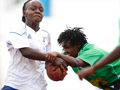 Fatuma Mohamed (R) of National Cereals and Produce Board’s tackles Merina Adala of Nairobi Water during their Kenya Handball Federation women’s League match at the Nyayo National Stadium Handball Courts in Nairobi on May 3, 2015.Nairobi water won 35-20. Photo/Stafford Ondego/www.pic-centre.com. (KENYA).