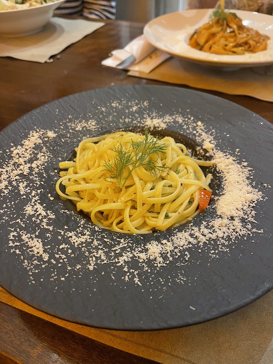 Gluten free spaghetti presented on a different coloured plate to regular pasta