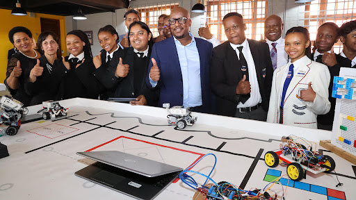 Gauteng education MEC Matome Chiloane, flanked by learners at the launch of the STEM lab.