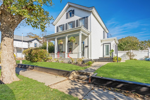 White house with front porch in this luxury farmhouse for rent in Greenport ($12,000)