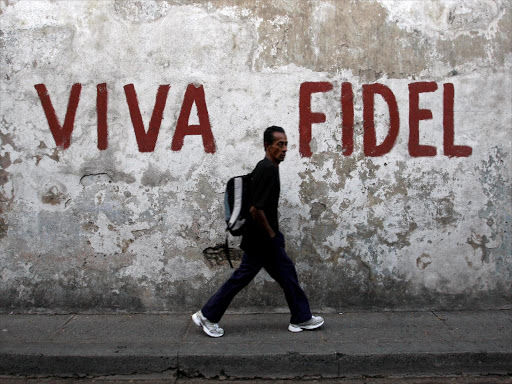 A man walks past a graffitti that reads "Long live Fidel" in Santiago de Cuba in this December 29, 2008 file photo. /REUTERS