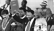 President Mandela with a copy of the new constitution in 1996