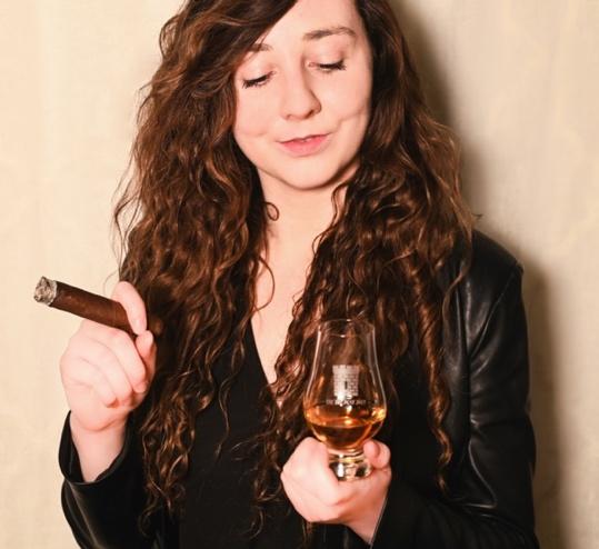 A person holding a glass of wine Description automatically generated with low confidence